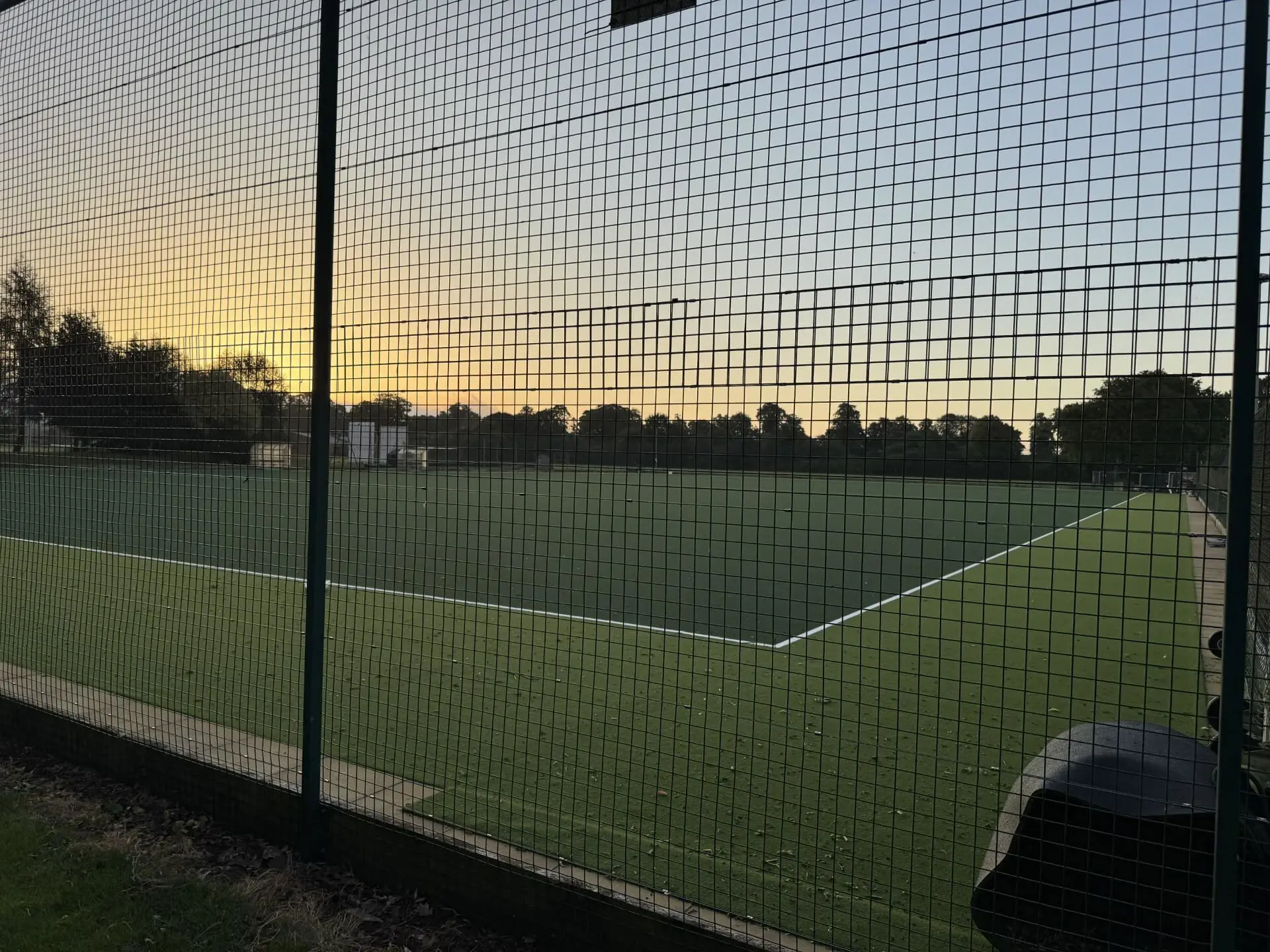 New Pocklington School astroturfs with the sun setting in the background. 