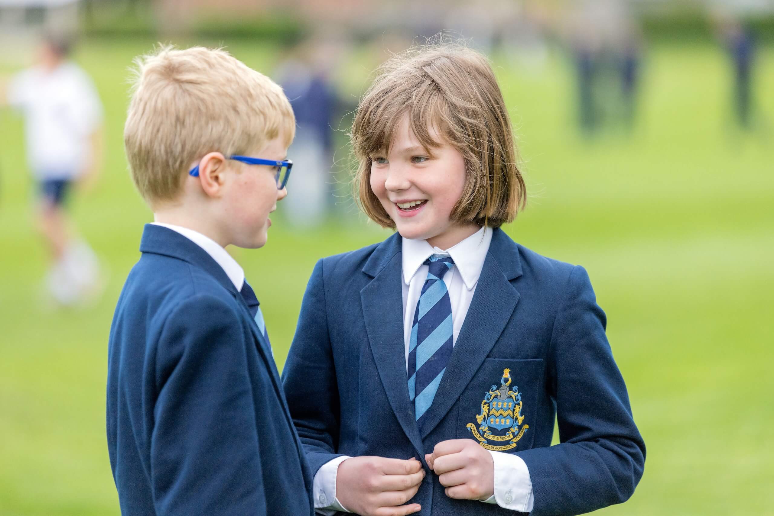 Two pupils talking together outside at Pocklington Prep School a top private day and baording school in Yorkshire near York, Beverley and Hull.