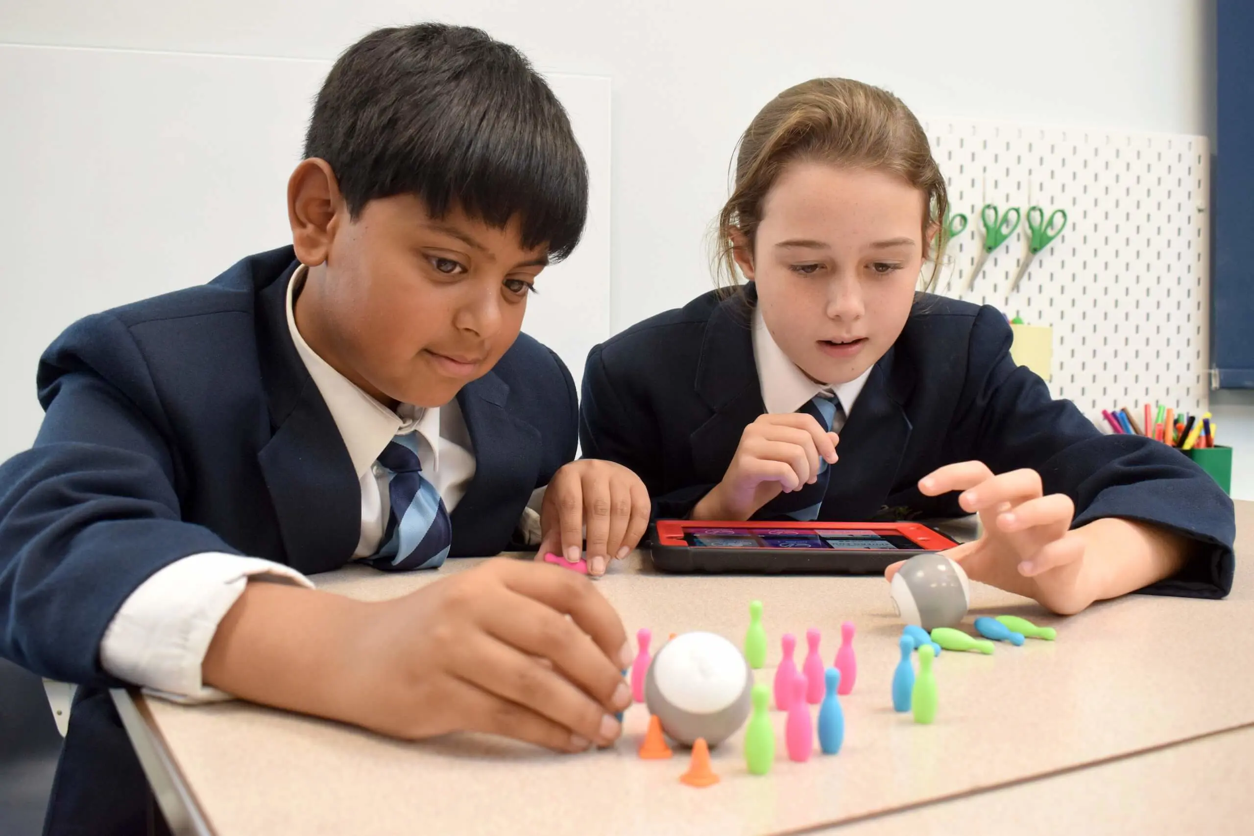 Pupils play a mini bowling game together using an iPad at Pocklington Prep School a top day and boarding private school near York, Beverley and Hull.