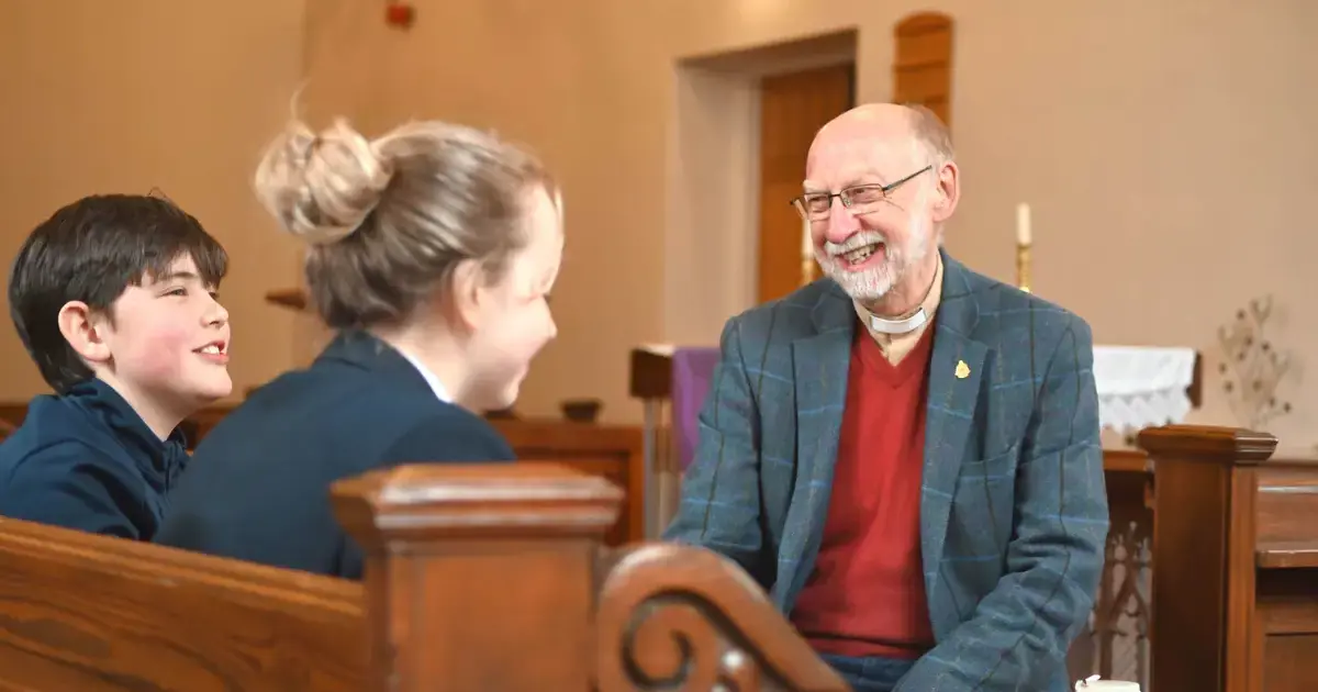 The Chaplain at Pocklington School and pupils chatting and smiling in the chapelPage Image