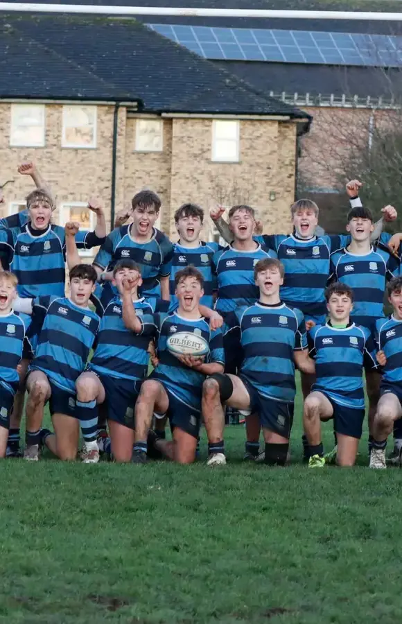 Pocklington School rugby players cheering and smiling after a match