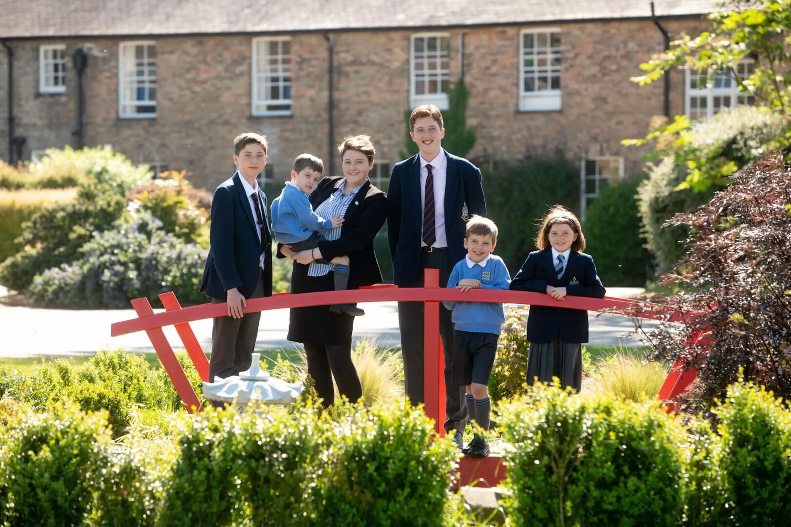 Family of Pocklington School pupils standing on the bridge outside the Art and Design 