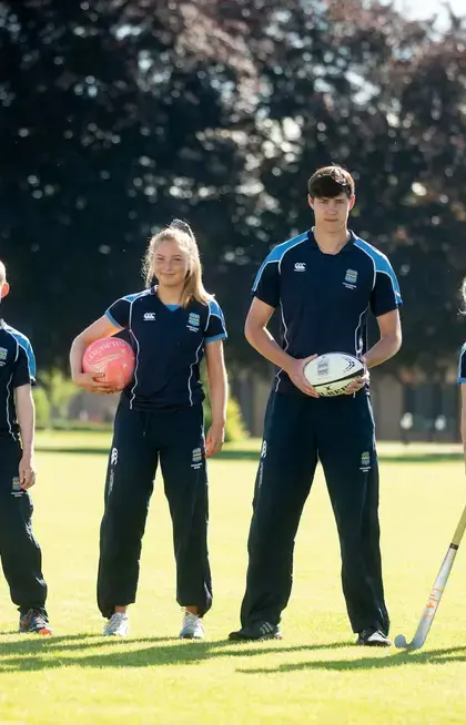 Pocklington School pupils standing proudly with sports kit
