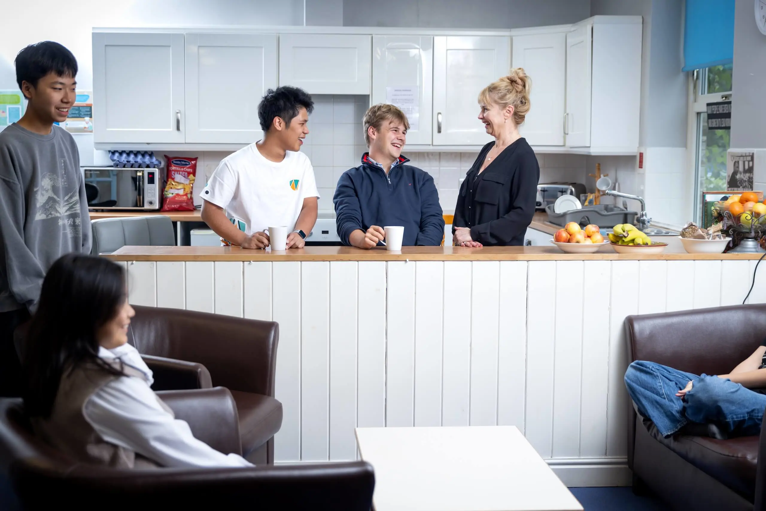 Pocklington School boarding boys in Boarding House drinking tea with staff