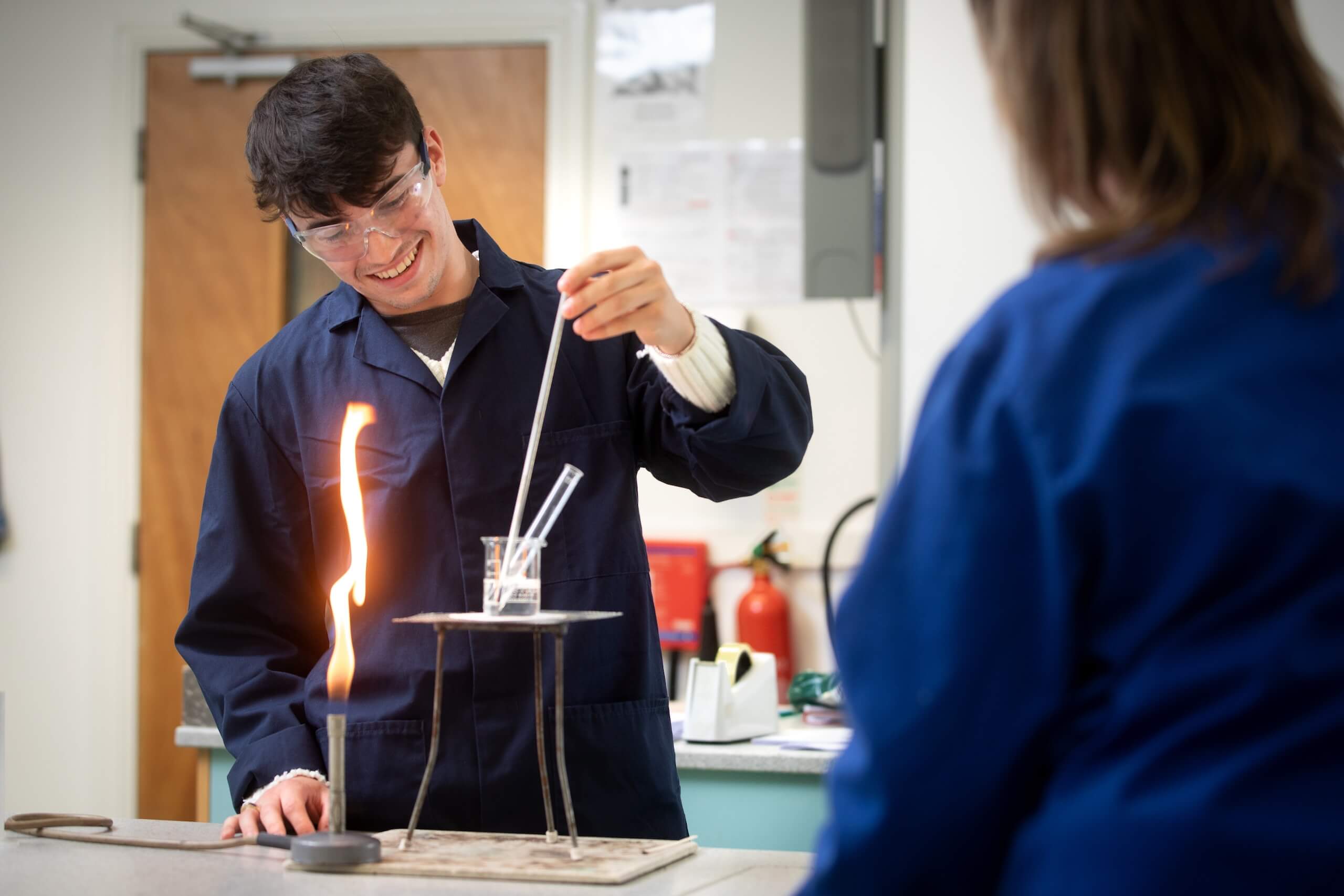 Pocklington School Sixth Former in chemistry class with bunsen burner and test tube