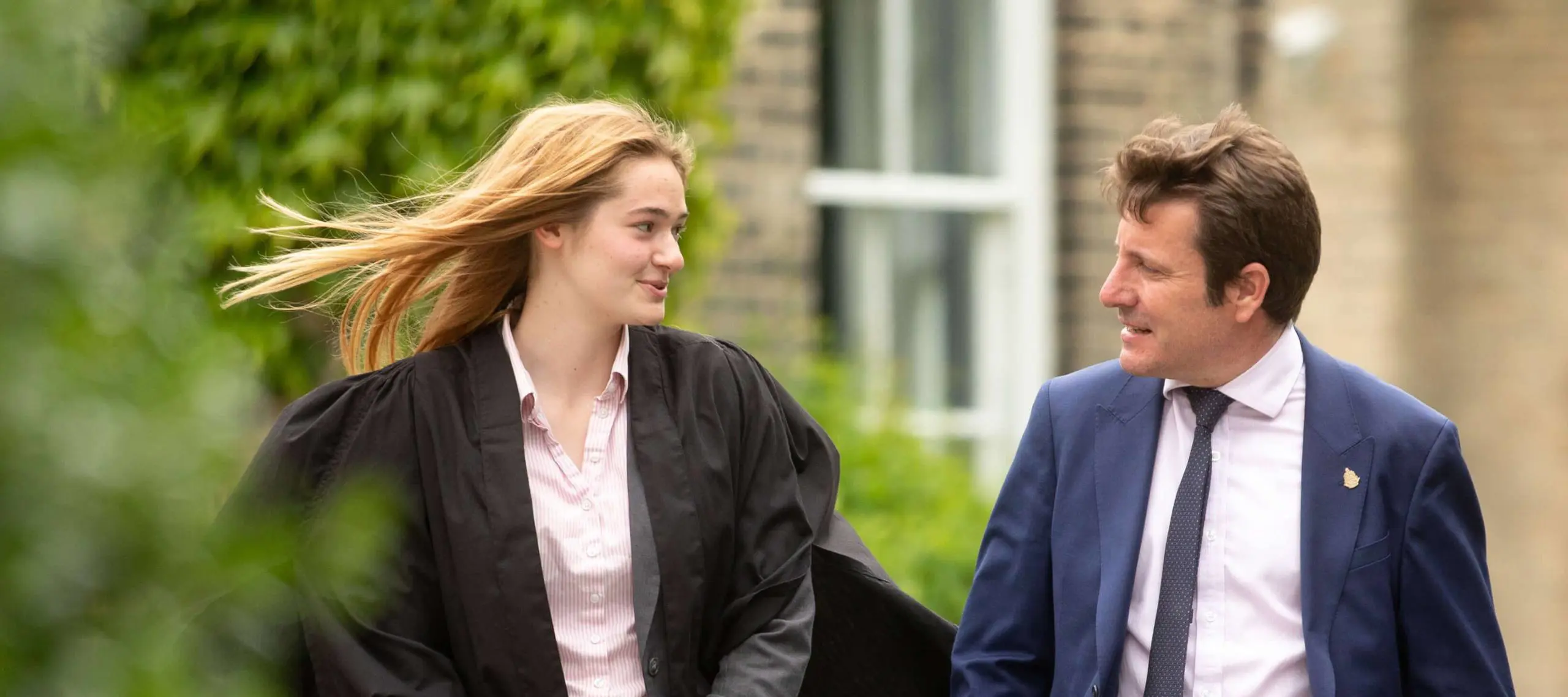 Pocklington School prefect in gown talking to teacher outside