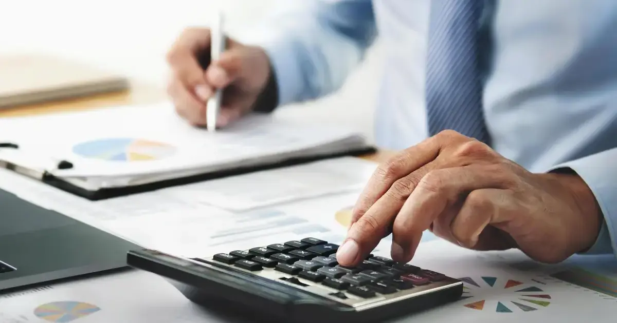 A business person using a calculatorPage Image,A 