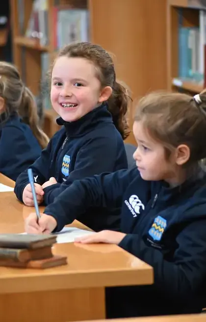 Prep School pupil smiling a lesson in the library at Pocklington School, a private school near Hull, in Yorkshire